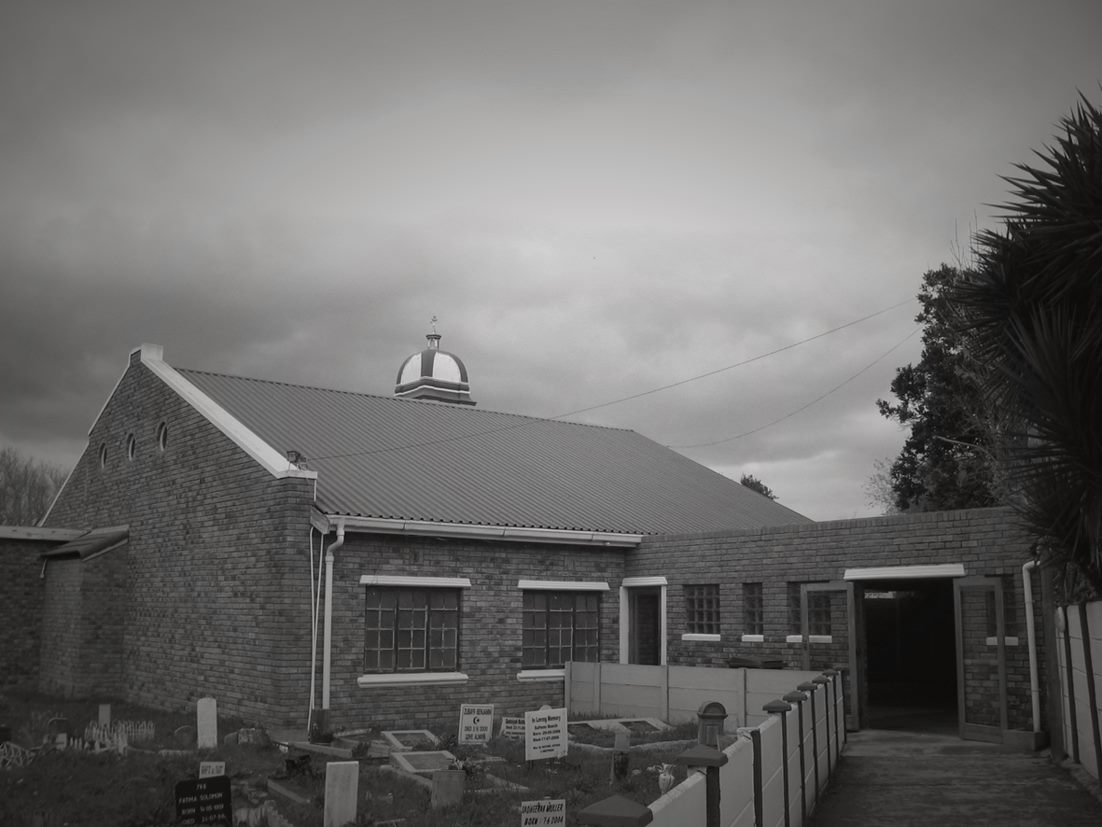 The Muslim cemetery on Spaanschemat River Road with Masjid Monier behind it